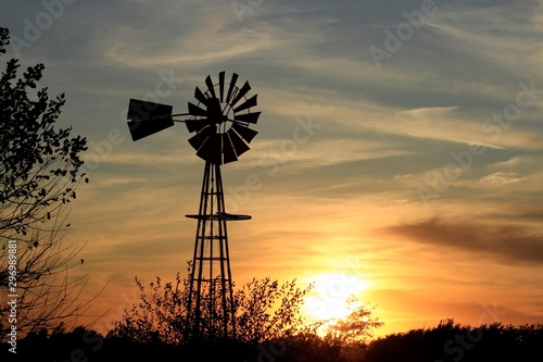 windmill at sunset in Kansas out in the country.