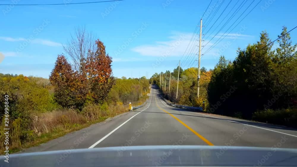 Rear View From Back of Car Driving Rural Countryside Road During Day. Car Point of View POV Behind Vehicle Country Street. Rear View From Back of Car Driving Rural Countryside Road During Day. Car Point of View POV Behind Vehicle Country Street.