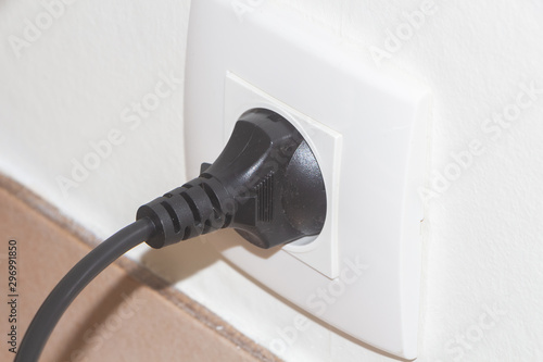 Plug in a socket in the wall of an house