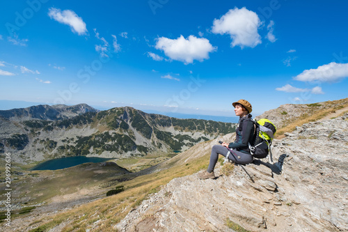 Young woman traveler in the bulgarian mountains , hiking in the sunny day