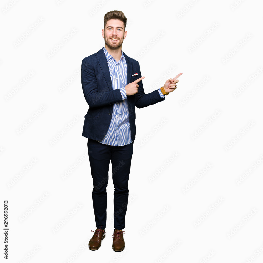 Young handsome bussines man smiling and looking at the camera pointing with two hands and fingers to the side. Young handsome bussines man smiling and looking at the camera pointing with two hands and fingers to the side.