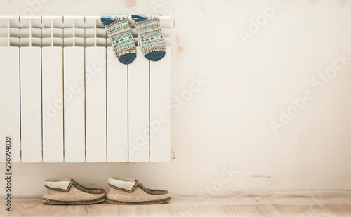 colorful warm winter socks drying on radiator.