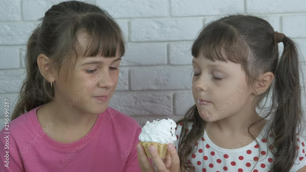Sisters eat one cake together. Sisters eat one cake together.