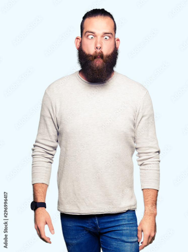 Young blond man wearing casual sweater making fish face with lips, crazy and comical gesture. Funny expression. Young blond man wearing casual sweater making fish face with lips, crazy and comical gesture. Funny expression.