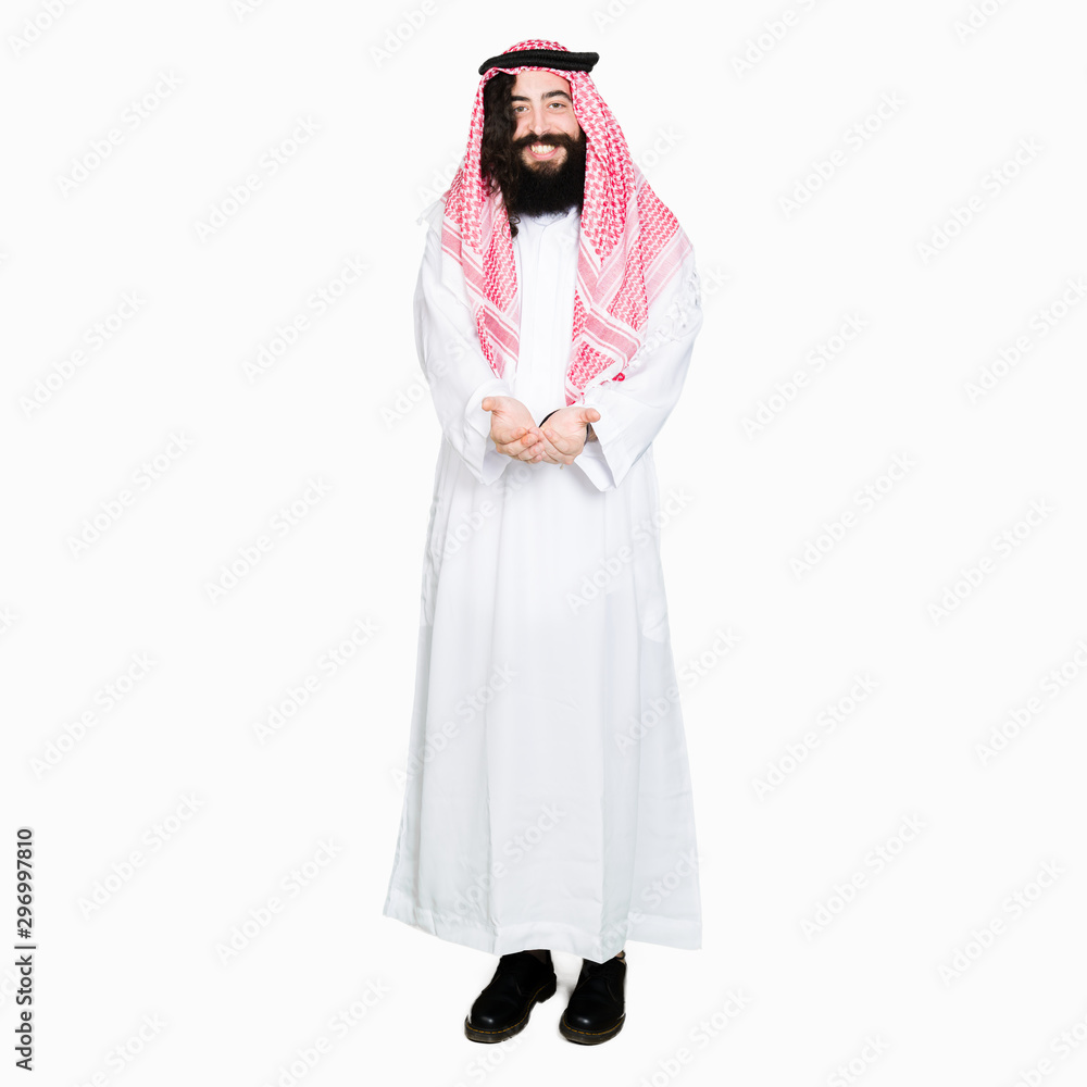 Arabian business man with long hair wearing traditional keffiyeh scarf Smiling with hands palms together receiving or giving gesture. Hold and protection Arabian business man with long hair wearing traditional keffiyeh scarf Smiling with hands palms together receiving or giving gesture. Hold and protection
