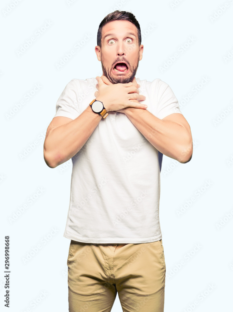 Handsome man wearing casual white t-shirt shouting and suffocate because painful strangle. Health problem. Asphyxiate and suicide concept. Handsome man wearing casual white t-shirt shouting and suffocate because painful strangle. Health problem. Asphyxiate and suicide concept.