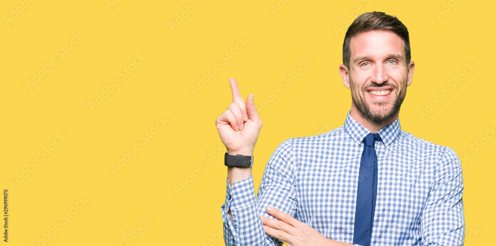 Handsome business man wearing tie with a big smile on face, pointing with hand and finger to the side looking at the camera. Handsome business man wearing tie with a big smile on face, pointing with hand and finger to the side looking at the camera.