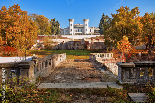 Beautiful old white castle surrounded by landscape park, fall season outdoor background photo