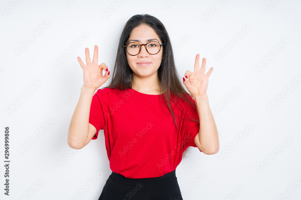 Beautiful brunette woman wearing glasses over isolated background relax and smiling with eyes closed doing meditation gesture with fingers. Yoga concept. Beautiful brunette woman wearing glasses over isolated background relax and smiling with eyes closed doing meditation gesture with fingers. Yoga concept.
