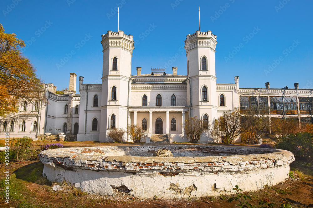 Beautiful old white castle surrounded by landscape park, fall season outdoor background