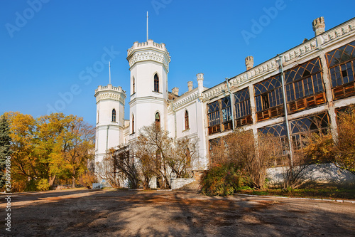 Beautiful old white castle surrounded by landscape park, fall season outdoor background photo