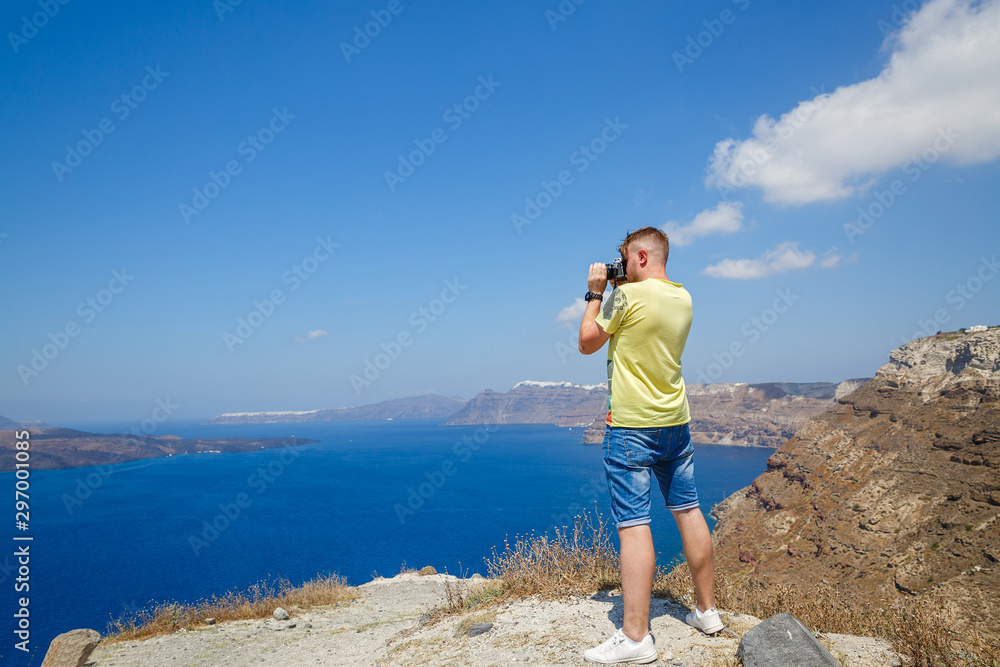 Man photographs the landscape of Santorini