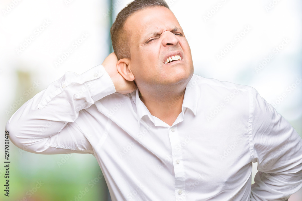 Middle age arab elegant man over isolated background Suffering of neck ache injury, touching neck with hand, muscular pain Middle age arab elegant man over isolated background Suffering of neck ache injury, touching neck with hand, muscular pain
