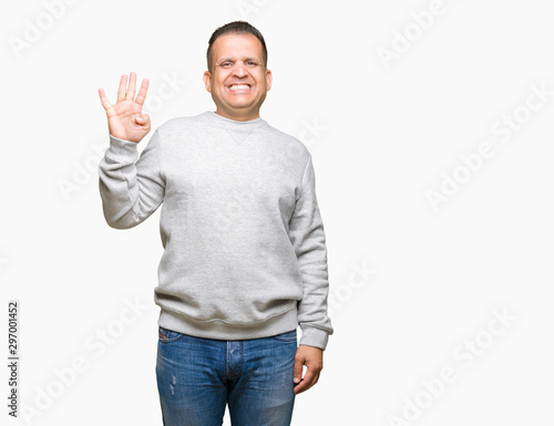 Middle age arab man wearing sport sweatshirt over isolated background showing and pointing up with fingers number four while smiling confident and happy. © Krakenimages.com