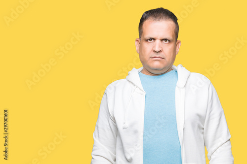 Middle age arab man wearing sweatshirt over isolated background Relaxed with serious expression on face. Simple and natural looking at the camera.