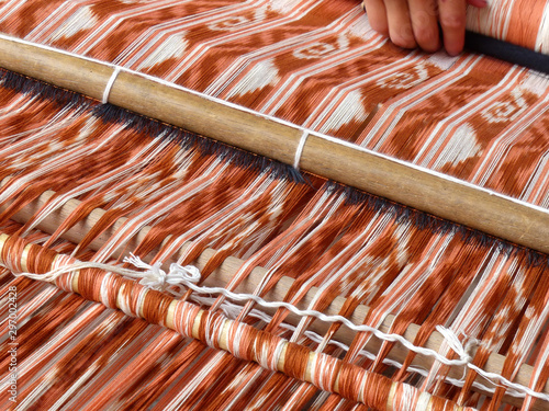Close up of traditional weaving technique IKAT for making scarfs or Macana or other fabric by hand with cotton threads, design are traditional for Gualaceo canton, Azuay province, Ecuador photo