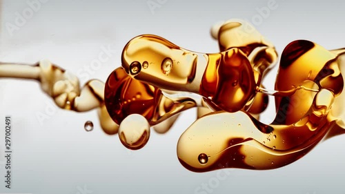 transparent orange gold oil bubbles and fluid shapes in purified water on a white gradient background. Side angle with crystal colored bubbles in purified cosmetic water backdrop with copy space for s