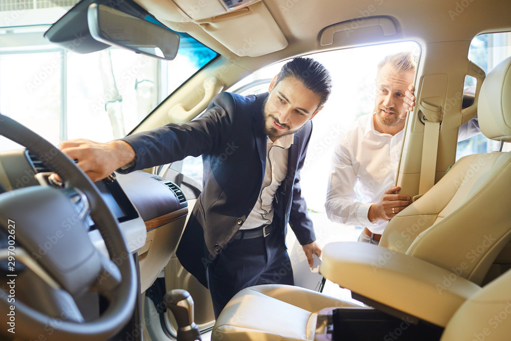 Professional salesmen selling cars at dealership to buyer Professional salesmen selling cars at dealership to buyer
