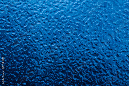 Icy patterns on a car window. Great abstract blue background
