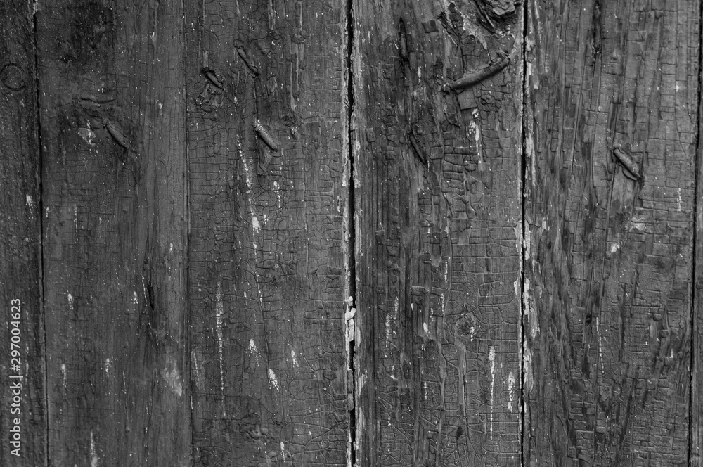 Naklejka premium Black and white wooden boarded wall with cracked paint background