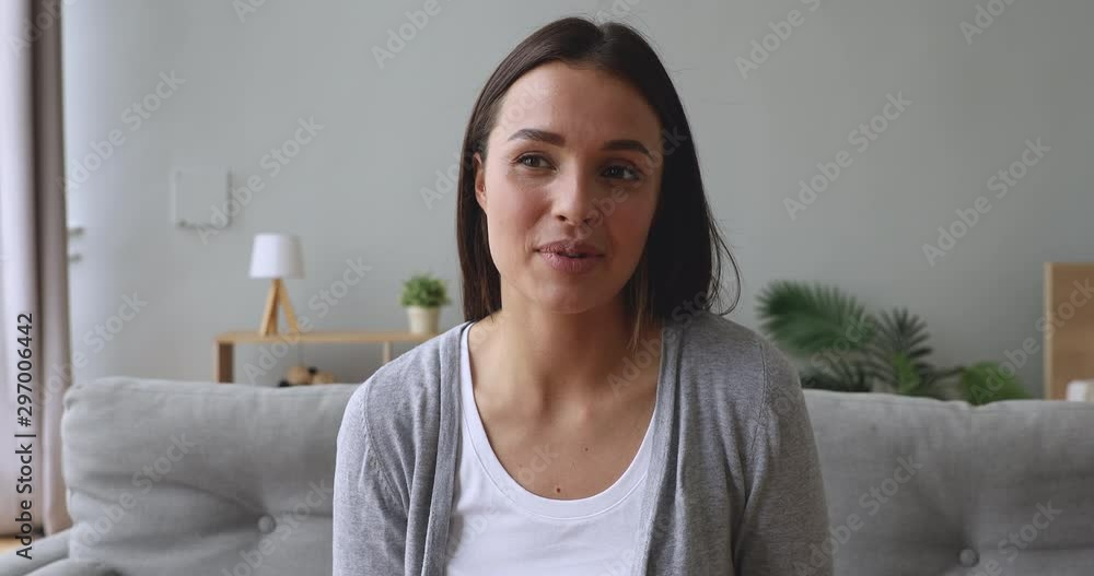 Young beautiful woman looking talking to camera at home Young beautiful woman looking talking to camera at home