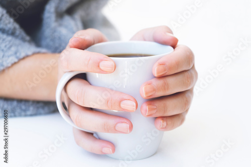 hands holding hot cup of coffee or tea