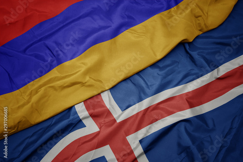 waving colorful flag of iceland and national flag of armenia.