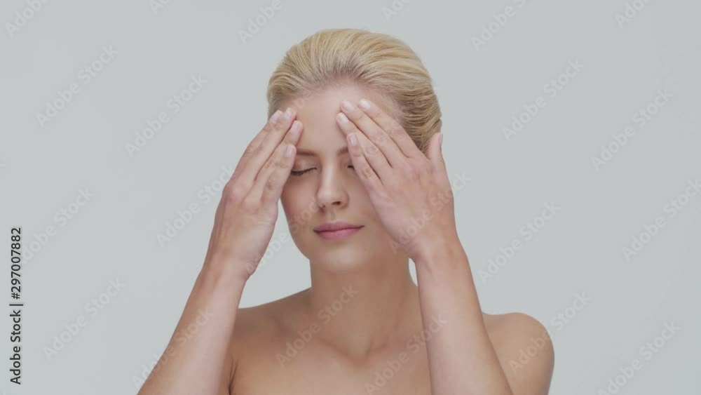 Studio portrait of young, beautiful and natural blond woman applying skin care cream. Face lifting, cosmetics and make-up. Studio portrait of young, beautiful and natural blond woman applying skin care cream. Face lifting, cosmetics and make-up.