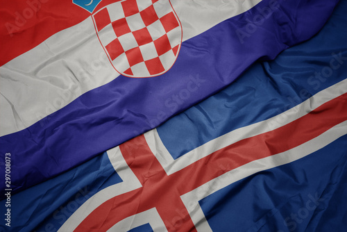 waving colorful flag of iceland and national flag of croatia.