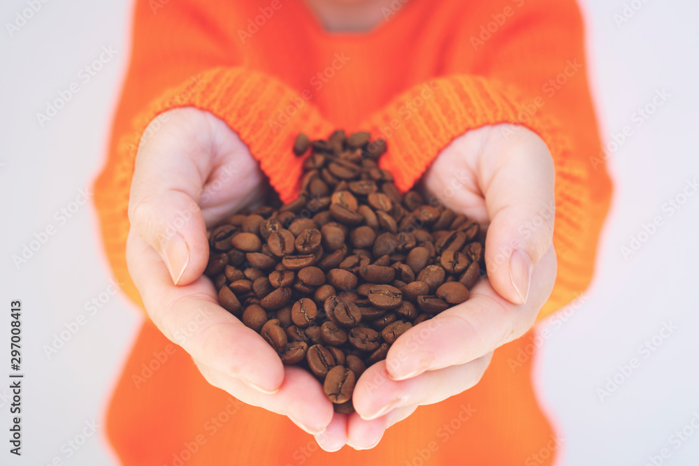 coffee beans in human hands, in soft focus, in shape of heart coffee beans in human hands, in soft focus, in shape of heart