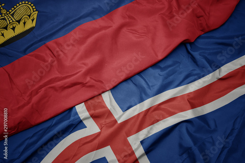 waving colorful flag of iceland and national flag of liechtenstein.