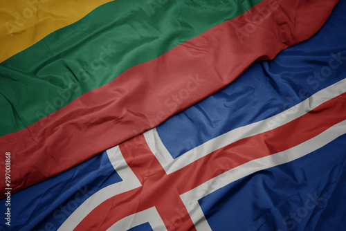 waving colorful flag of iceland and national flag of lithuania.