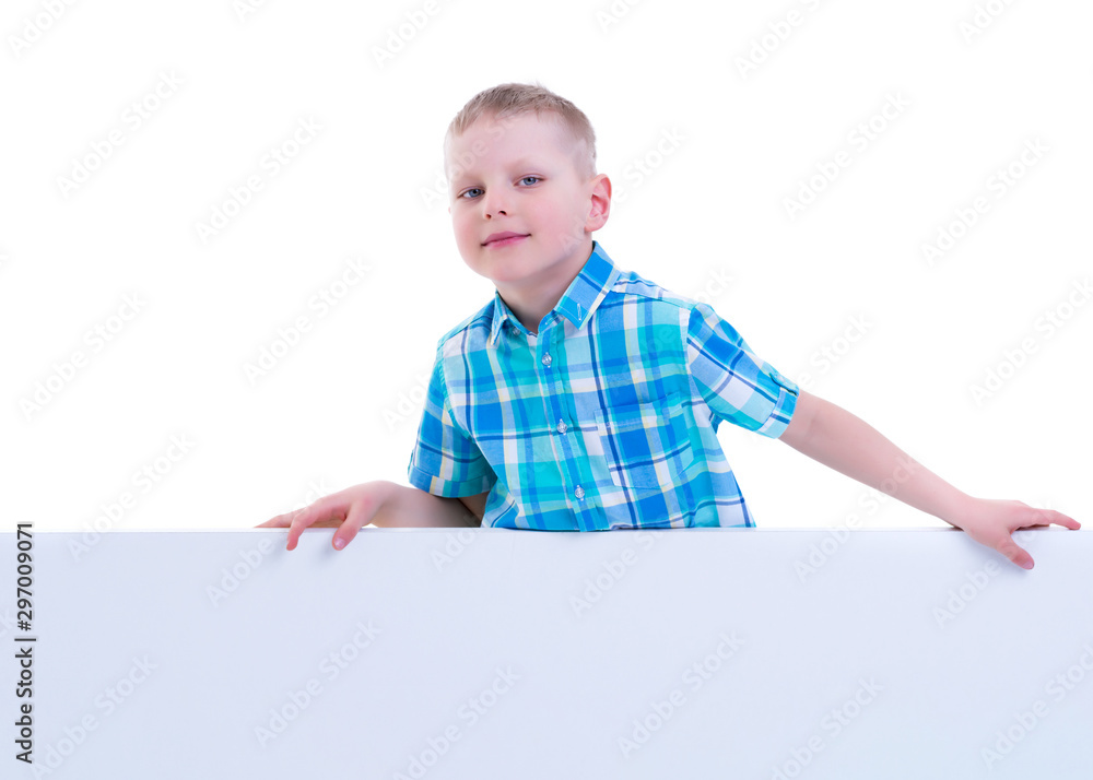 A little boy is looking from behind an empty banner. A little boy is looking from behind an empty banner.