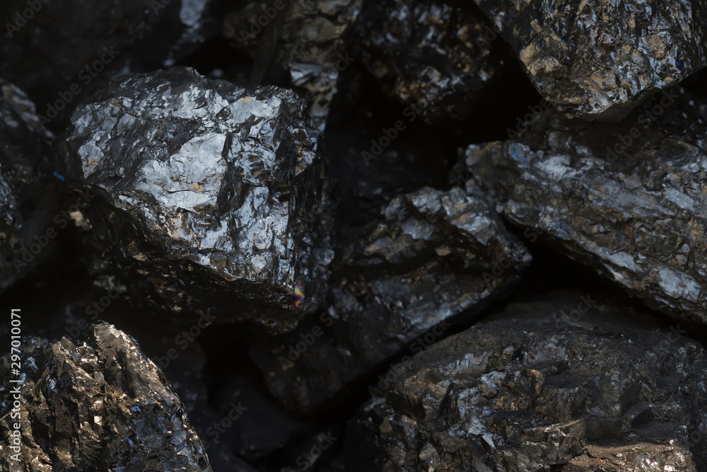 Black coal mine close-up with soft focus. Anthracite coal bar on dark background. Natural black coal bars for background. Industrial coal nuggets close up Black coal mine close-up with soft focus. Anthracite coal bar on dark background. Natural black coal bars for background. Industrial coal nuggets close up