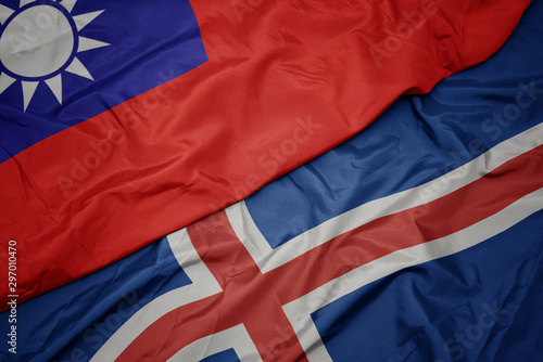 waving colorful flag of iceland and national flag of taiwan.