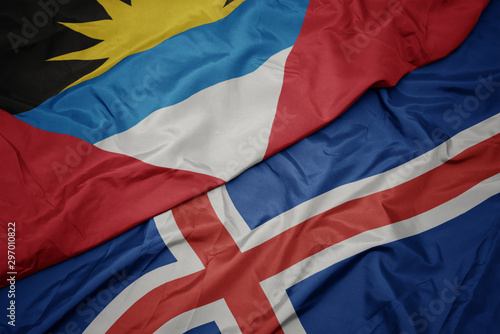 waving colorful flag of iceland and national flag of antigua and barbuda.