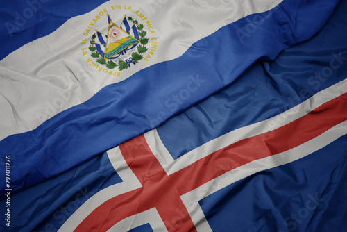 waving colorful flag of iceland and national flag of el salvador.