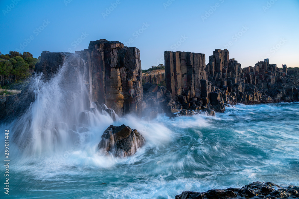 Bombo Quarry Headland, NSW, Australia. Morning sunrise with sea waves crashing onto the rugged coastline. Bombo Quarry Headland, NSW, Australia. Morning sunrise with sea waves crashing onto the rugged coastline.