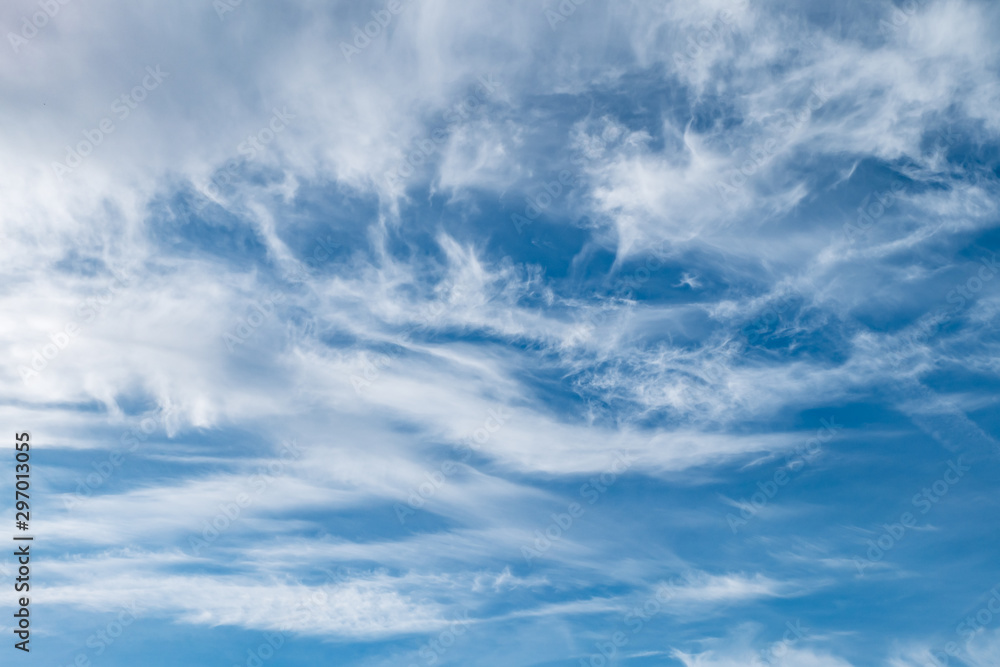 Blue sky background with tiny stratus cirrus striped clouds. Clearing day and Good windy weather Blue sky background with tiny stratus cirrus striped clouds. Clearing day and Good windy weather