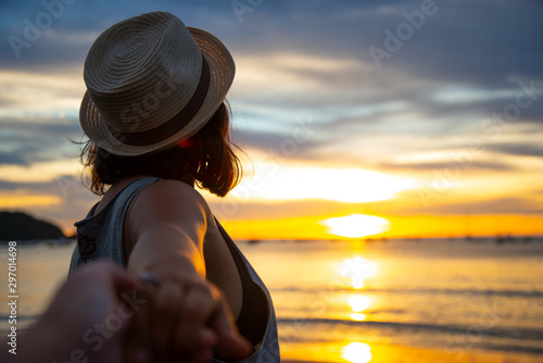 young women with hat in sunset