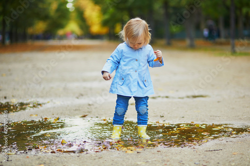 Child wearing yellow rain boots and jumping in puddle © Ekaterina Pokrovsky