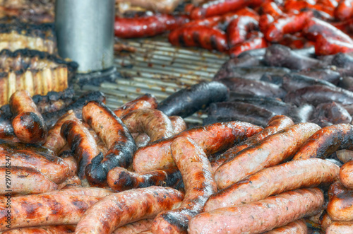 Some different meats cooked at outdoor. Big barbecue with creole sausage, blood sausage, spicy pork sausage and ribs. Typical foods of Spain in festivals and fairs.