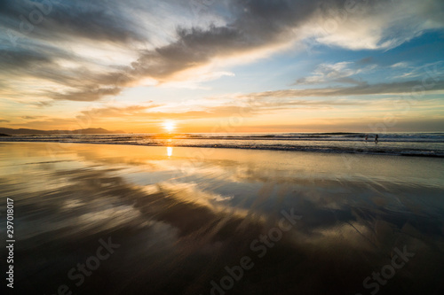 Beautiful scenic panoramic view of a colorful sunset on the beach at the Atlantic Ocean, in north of Spain, Europe