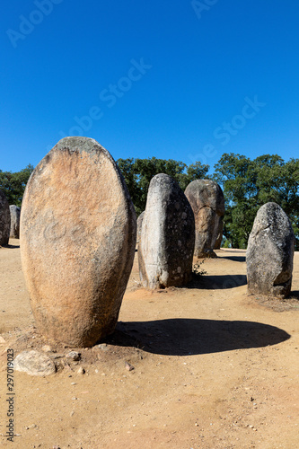 Granite standing stone, menhir, with other megalithic and neolithic standing stones at the Almendres Cromlech near Evora, Portugal