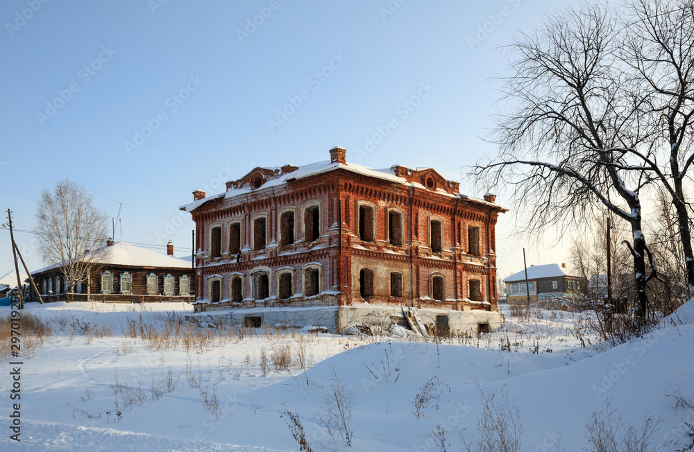 Abandoned historical residential house in winter. Village of Visim, Sverdlovsk region, Russia