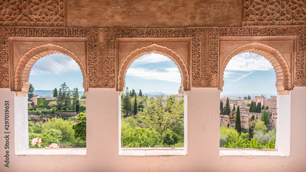 window over the heaven, tree arch windows in generalife ornate with arabic motif. alhambra. spain