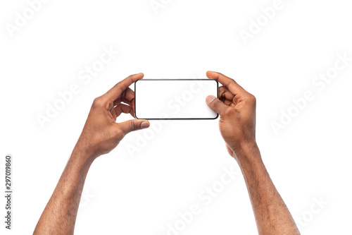 Black male hands taking photo on smartphone with blank screen