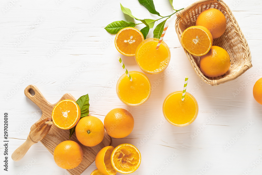 Orange juice. Freshly squeezed juice in glasses and fresh fruits with leaves, view from above - obrazy, fototapety, plakaty 