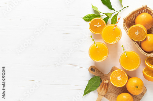 Orange juice. Freshly squeezed juice in glasses and fresh fruits with leaves, view from above photo