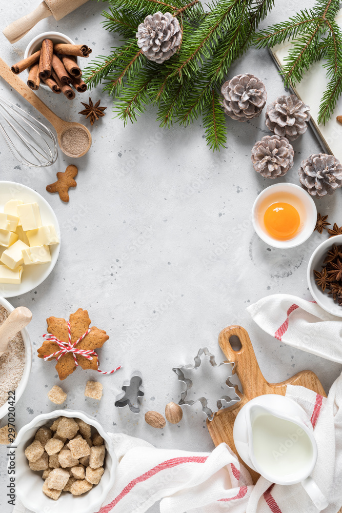 Christmas or Xmas baking culinary background. Ingredients for cooking pastry on kitchen table. New Year, X-mas or Noel holiday festive decorations with fir tree, copy space Christmas or Xmas baking culinary background. Ingredients for cooking pastry on kitchen table. New Year, X-mas or Noel holiday festive decorations with fir tree, copy space